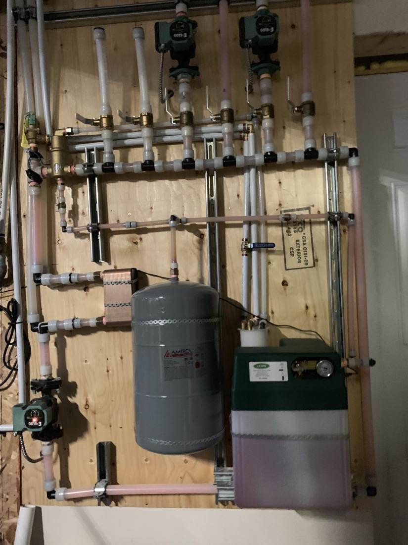 A hydronic heating board with circulator pumps, an expansion tank and a boiler fill unit, all piped in PEX